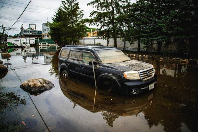 A car is partially submerged on the street as a result of heavy flooding in the Elmsford area of Westchester, New York, U.S., July 15, 2025. (Photo by Eduardo Munoz/Reuters)