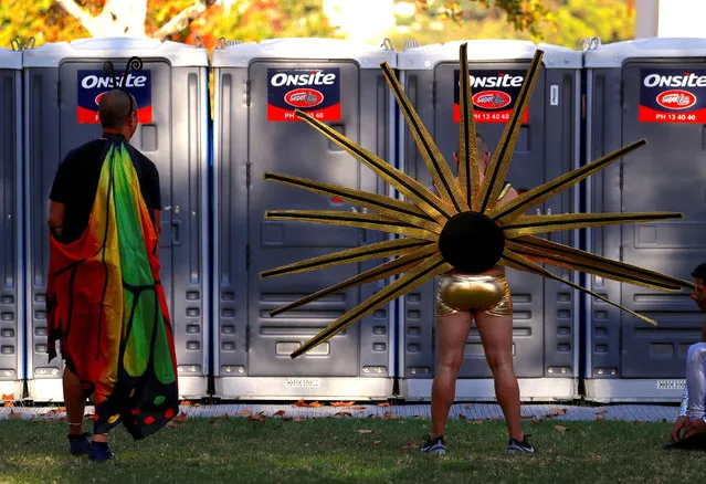 Participants wearing costumes wait to use portable toilets before the 40th anniversary of the Sydney Gay and Lesbian Mardi Gras Parade in central Sydney, Australia, March 3, 2018. (Photo by David Gray/Reuters)
