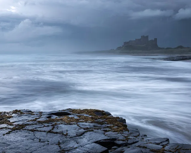 “Bamburgh beach, Northumberland, in August, just after a storm. The rollers are pushing in on this wonderful beach amid mist and spray and a hint of a sunset”. (Photo by Ruth Grindrod/The Guardian)