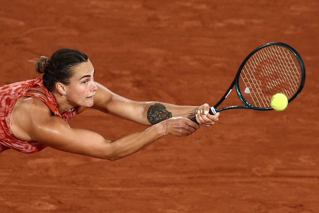 Belarus' Aryna Sabalenka plays a backhand return to Russia's Erika Andreeva during their women's singles match on Court Philippe-Chatrier on day three of the French Open tennis tournament at the Roland Garros Complex in Paris on May 28, 2024. (Photo by Anne-Christine Poujoulat/AFP Photo)