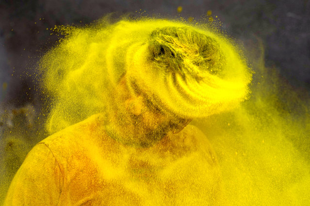 A trainer at a gymnasium plays Holi, the Hindu festival of colors, in Prayagraj, in the northern Indian state of Uttar Pradesh, India. Tuesday, March 7, 2023.  After two years of subdued festivities due to COVID-19, the Holi celebrations brought the revelers back on the streets, smearing each other’s faces with bright powdered color, distributing sweets and squirting water at fellow festival-goers. Holi, also marks the arrival of spring. (AP Photo/Rajesh Kumar Singh)