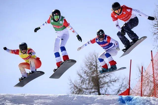 (L-R) Sophie Hediger of Switzerland, Chloe Trespeuch of France, Alexia Queyrel of France and Lindsey Jacobellis of the United States speed down the track during the women's FIS Snowboard Cross World Cup, SBX, in Veysonnaz, Switzerland, 16 March 2023. (Photo by Laurent Gillieron/EPA)