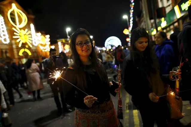 A woman holds a sparkler during Diwali celebrations in Leicester, Britain November 11, 2015. (Photo by Darren Staples/Reuters)