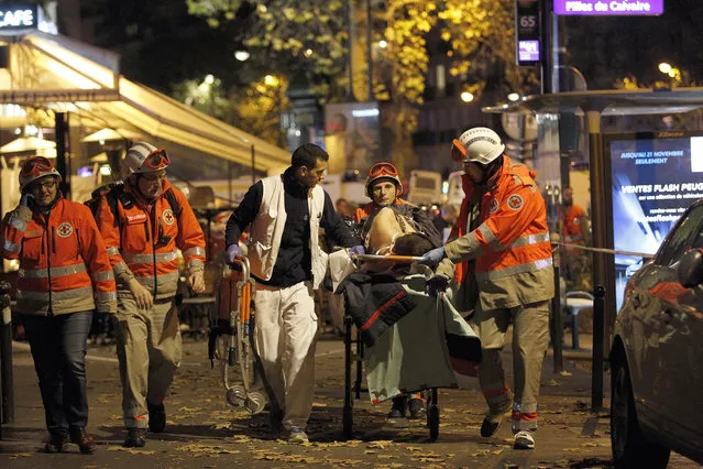Medics evacuate an injured person on Boulevard des Filles du Calvaire, close to the Bataclan theater, early on November 14, 2015 in Paris, France. (Photo by Thierry Chesnot/Getty Images)