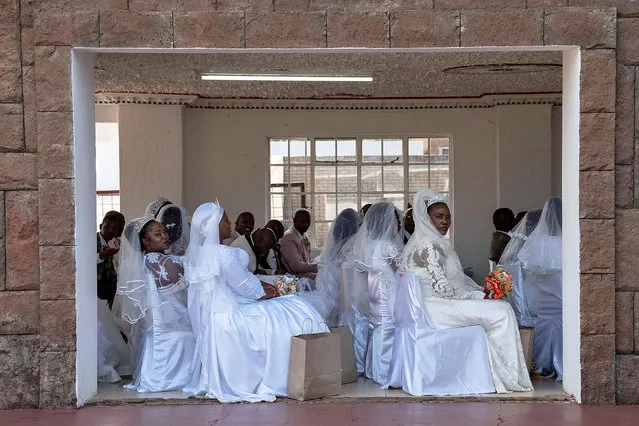 A group of brides are seen waiting at the International Pentecostal Holiness Church in Zuurbekom, south of Johannesburg, as they take part in a mass wedding ceremony where 80 couples got married during the Easter Sunday service on April 9, 2023. (Photo by Ihsaan Haffejee/AFP Photo)