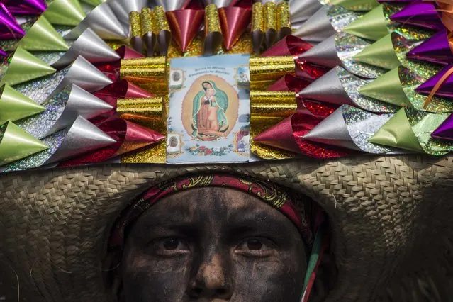 In this Saturday, May 5, 2018 photo, a child dressed as a revolutionary Zacapoaztla indigenous soldier attends the re-enactment of The Battle of Puebla between the Zacapoaztlas and French army during Cinco de Mayo celebrations in Mexico City. Cinco de Mayo commemorates the victory of an ill-equipped Mexican army over French troops in Puebla on May 5, 1862. (Photo by Christian Palma/AP Photo)