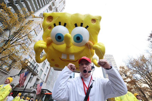 A man reacts as the SpongeBob SquarePants & Gary balloon flies during the Macy's Thanksgiving Day Parade 2025, in New York City, U.S., November 27, 2025. (Photo by Brendan McDermid/Reuters)
