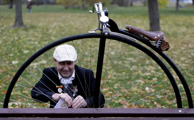 A man wearing a historical costume adjusts his high-wheel bicycle before the annual penny farthing race in Prague, Czech Republic November 5, 2016. (Photo by David W. Cerny/Reuters)