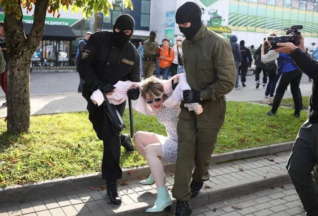 Belarusian law enforcement officers detain a woman during an opposition rally to protest against police brutality and to reject the presidential election results in Minsk, Belarus on September 19, 2020. (Photo by Tut.By via Reuters)
