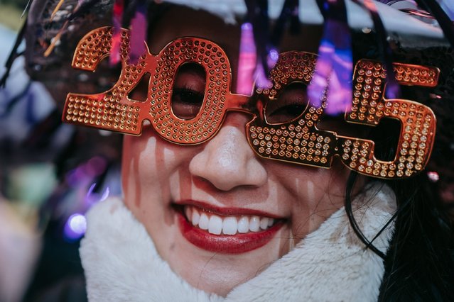 A reveler wears decorative glasses adorned with number 2025 to celebrate the new year in Times Square on New Year's Eve in New York, New York, USA, 01 January 2025. (Photo by Olga Federova/EPA/EFE)