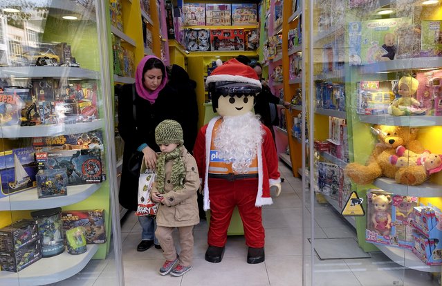 An Iranian Christian woman leaves with her child after shopping in preparations for Christmas in central Tehran December 23, 2015. (Photo by Raheb Homavandi/Reuters)