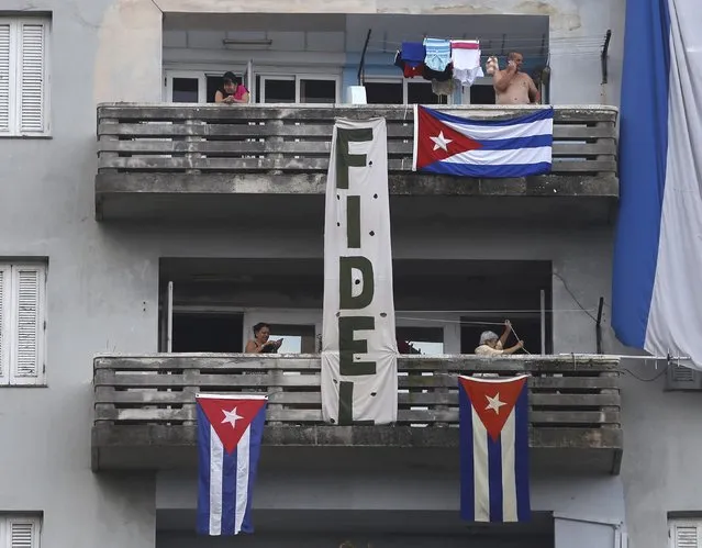 Cuban flags and a banner hang from a building in tribute to Cuba's late President Fidel Castro in Havana, November 30, 2016. (Photo by Reuters/Stringer)