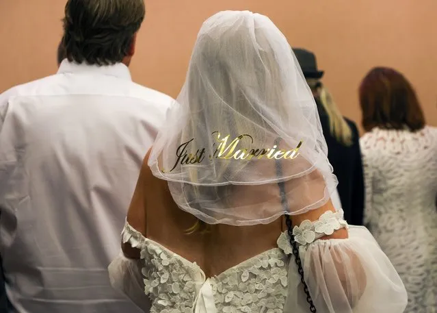 A woman wears a veil with the words “Just Married” on the back after participating in a wedding vow renewal ceremony for nearly 300 couples as Las Vegas celebrates 70 years as the Wedding Capital of the World at Caesars Palace on September 03, 2023 in Las Vegas, Nevada. Clark County, Nevada, has held more than five million weddings since 1953, when the Daily Herald in London published an article referring to Las Vegas as the "Wedding Capital of the World." (Photo by Ethan Miller/Getty Images)