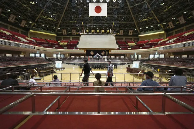 Elderly residents of Sumida Ward rest at box seats after receiving their first dose of Pfizer's COVID-19 vaccine at the Ryogoku Kokugikan sporting arena, in Tokyo Monday May 24, 2021. The arena, mainly used for sumo wrestling tournaments, is used as temporary inoculation venue for local residents age over 65 years old. (Photo by Eugene Hoshiko/AP Photo)