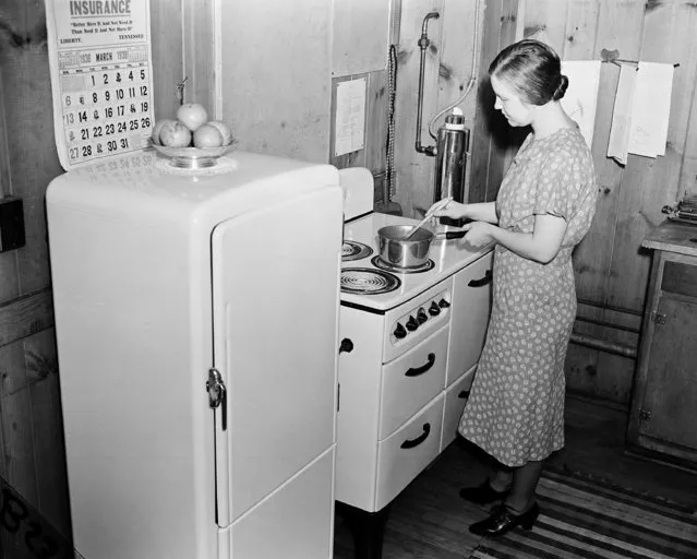 Mrs. W. R. New is shown with her electric ice box, electric stove and electric water heater in Norris, Tenn., on March 29, 1938. Mrs. New's husband works for the Tennessee Valley Authority (TVA). (Photo by Charles Gorry/AP Photo)