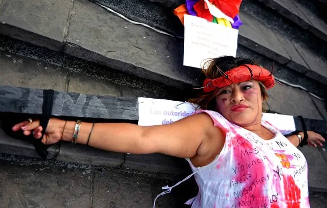 Norma Galicia aka “Pirulina” takes part in a demonstration during the commemoration of the International Day for the Elimination of Violence Against Women, in Guatemala City on November 25, 2013. So far this year, 696 women have died due to violent events in Guatemala. (Photo by Johan Ordonez/AFP Photo)