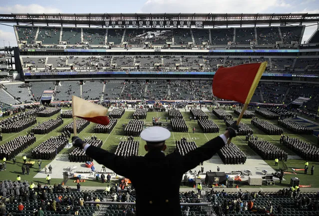 Navy Midshipman Frey Pankratz singles his classmates as they march onto the field ahead of an NCAA college football against the Army, Saturday, December 8, 2018, in Philadelphia. (Photo by Matt Rourke/AP Photo)