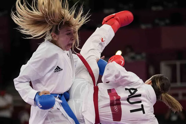 Bettina Plank of Austria, right, and Anzhelika Terliuga of Ukraine compete in the women's kumite -55kg elimination round for Karate at the 2020 Summer Olympics, Thursday, August 5, 2021, in Tokyo, Japan. (Photo by Vincent Thian/AP Photo)