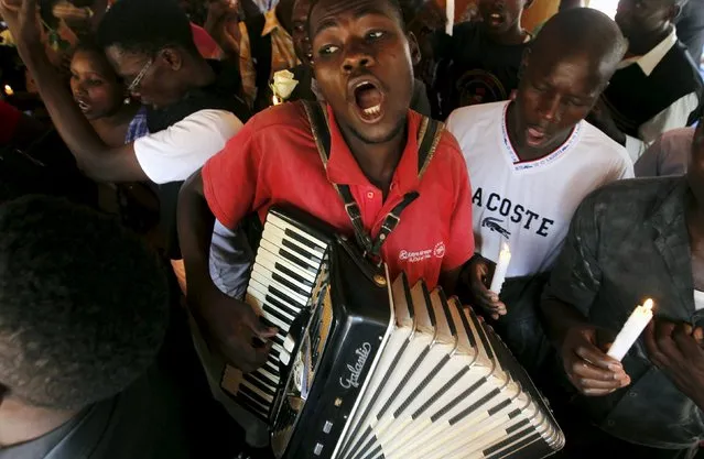 A man plays an accordion during a prayer session following an attack by gunmen at the Garissa University College campus, along the streets of the capital Nairobi, April 7, 2015. (Photo by Thomas Mukoya/Reuters)