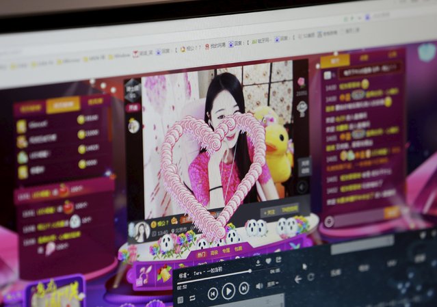 A digital gift is seen on the screen, which was bought and presented by a fan, as online hostess Xianggong gives a live broadcast in Beijing, February 10, 2015. (Photo by Jason Lee/Reuters)