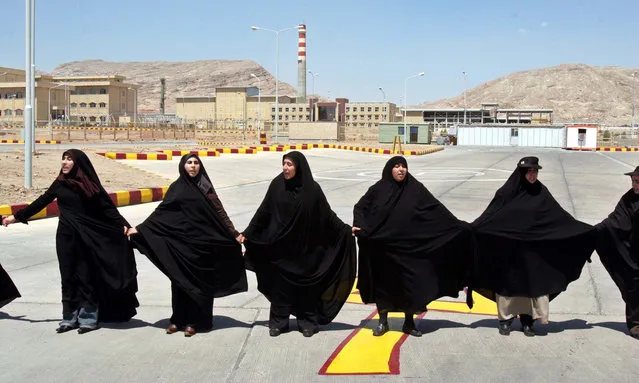 Women form a human chain at the uranium conversion facility, in support of Iran’s nuclear programme in Isfahan, Iran on August 16, 2021. (Photo by Vahid Salemi/AP Photo)