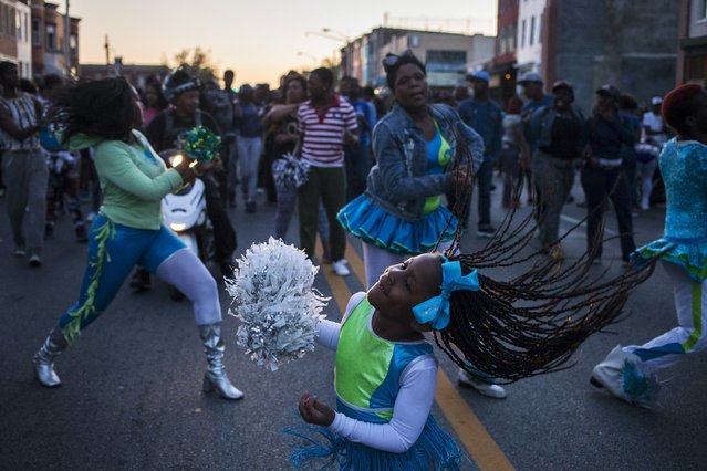 Residents dance to the drums of a community band near the corner of W North Avenue and Pennsylvania Avenue as others nearby protest (unseen) the death of 25-year-old black man Freddie Gray who died in police custody in Baltimore, Maryland April 28, 2015. (Photo by Adrees Latif/Reuters)