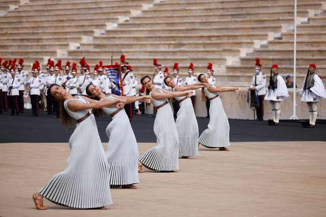 Actresses in the role of priestesses perform during the Olympic flame handover ceremony at Panathinean stadium in Athens on October 19, 2021. The flame will be transported by torch relay to Beijing, China, which will host the 2022 Winter Olympics from February 4-20, 2022. (Photo by Alkis Konstantinidis/Reuters)