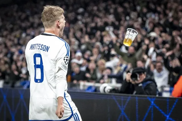 A plastic glass with beer flies towards FC Copenhagen's Danish forward #08 Magnus Mattsson as he celebrates the 1-1 during the UEFA Champions League round of 16, first-leg football match between FC Copenhagen and Manchester City in Copenhagen, Denmark, on February 13, 2024. (Photo by Mads Claus Rasmussen/Ritzau Scanpix via AFP Photo)