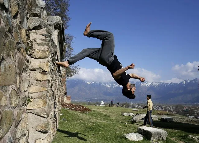 Kashmiri Muslim traceurs display their Parkour skills in an open field in the lap of Koh-e-Maraan (Hari Parbhat) hillock in downtown Srinagar, Kashmir, India on 15 March 2016. Parkour, developed in France, is an athletic discipline in which practitioners or traceurs combine skills of gymnastics, acrobatics, running, and jumping to traverse a variety of terrain, is becoming incresingly popular among the Kashmiri Muslim youth. (Photo by Rarooq Khan/EPA)