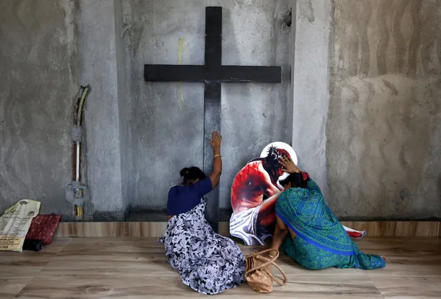 Women pray inside a church ahead of Good Friday celebrations in Kolkata, India, April 18, 2019. (Photo by Rupak De Chowdhuri/Reuters)