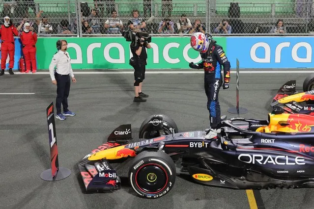 Red Bull Racing's Dutch driver Max Verstappen jumps off his car as he celebrates winning the Saudi Arabian Formula One Grand Prix at the Jeddah Corniche Circuit in Jeddah on March 9, 2024. (Photo by Giuseppe Cacace/AFP Photo)