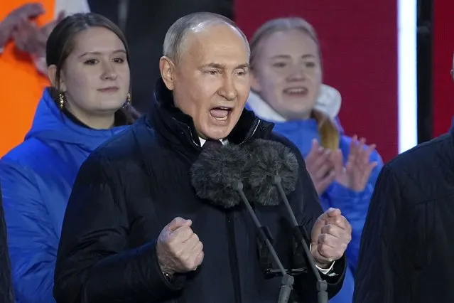 Russian President Vladimir Putin gestures while addressing a crowd at a concert marking his victory in a presidential election and the 10-year anniversary of Crimea's annexation by Russia on Red Square in Moscow, Russia, Monday, March 18, 2024. President Vladimir Putin seized Crimea from Ukraine a decade ago, a move that sent his popularity soaring but was widely denounced as illegal. (Photo by Alexander Zemlianichenko/AP Photo)