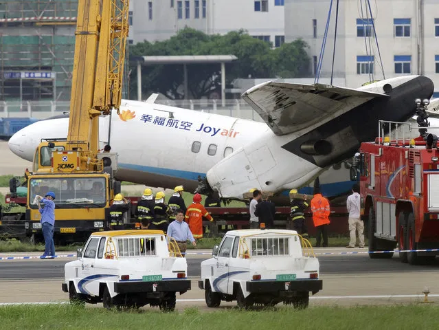 In this photo released by China's Xinhua News Agency, rescuers work at the accident site at Changle International Airport in Fuzhou, capital of southeast China's Fujian Province Sunday, May 10, 2015. A plane operated by Chinese domestic carrier Joyair veered off a runway upon landing in the southeastern city of Fuzhou on Sunday, the airline said. (Photo by Jiang Kehong/Xinhua via AP Photo)