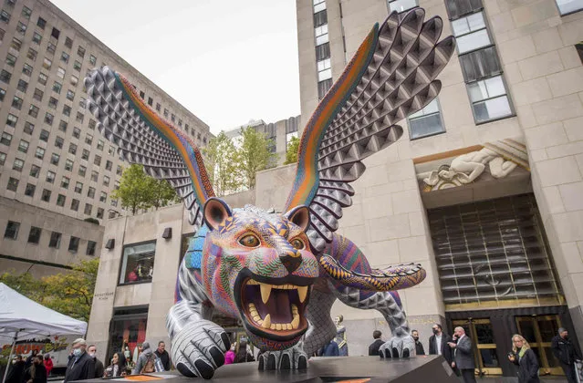 An “alebrije” titled Guardian #2, a fusion of jaguar and eagle, by Atelier Jacobo & María Ángeles, greets visitors to Mexico Week: Día de Muertos at Rockefeller Center, Friday, October 29, 2021, in New York. Two “alebrijes”, along with other art installations celebrating Day of the Dead and the heritage of Mexico, will be on display through Nov. 2. (Photo by Diane Bondareff/AP Images for Tishman Speyer)
