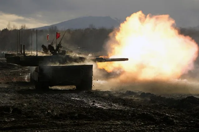 Japanese Ground-Self Defense Force (JGDDF) Type 90 tank fires its gun at a target during a live-fire annual exercise at the Minami Eniwa Camp Monday, December 6, 2021, in Eniwa, on the northern Japan island of Hokkaido. Dozens of tanks are rolling over the next two weeks on Hokkaido, a main military stronghold for a country with perhaps the world's most little known yet powerful army. (Photo by Eugene Hoshiko/AP Photo)