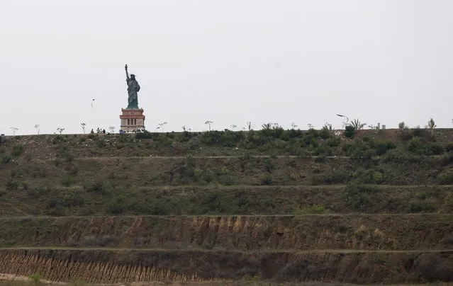 A replica of the Statue of Liberty stands on a hill overlooking the construction of new homes in Bahria Town on the outskirts of Islamabad, Pakistan March 16, 2016. (Photo by Caren Firouz/Reuters)