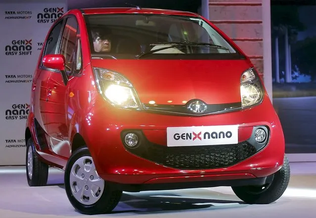 Mayank Pareek, President of Tata Motors' Passenger Vehicle Business Unit (PVBU), drives the company's new “GenX Nano” car during its launch in Mumbai, India, May 19, 2015. The new version of the Nano comes with a starting price of 199,000 rupees ($3,127.21) and other Automated Transmission Mode. (Photo by Shailesh Andrade/Reuters)