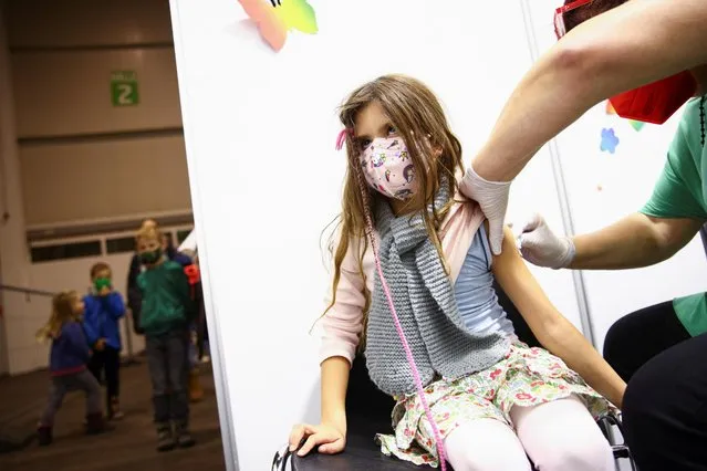 Marie, 7, receives a dose of the vaccine at a coronavirus disease (COVID-19) vaccination centre for children, in Tulln, Austria on December 1, 2021. (Photo by Lisi Niesner/Reuters)