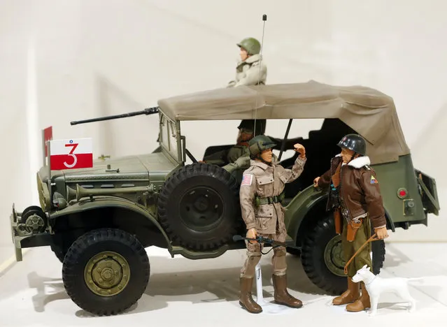 This January 31, 2014 photo shows a Gen. George Patton G.I. Joe action figure, right, and other G.I. Joes in a display at the New York State Military Museum  in Saratoga Springs, N.Y. A half-century after the 12-inch doll was introduced at a New York City toy fair, the iconic action figure is being celebrated by collectors with a display at the military museum, while the toy's maker plans other anniversary events to be announced later this month. (Photo by Mike Groll/AP Photo)