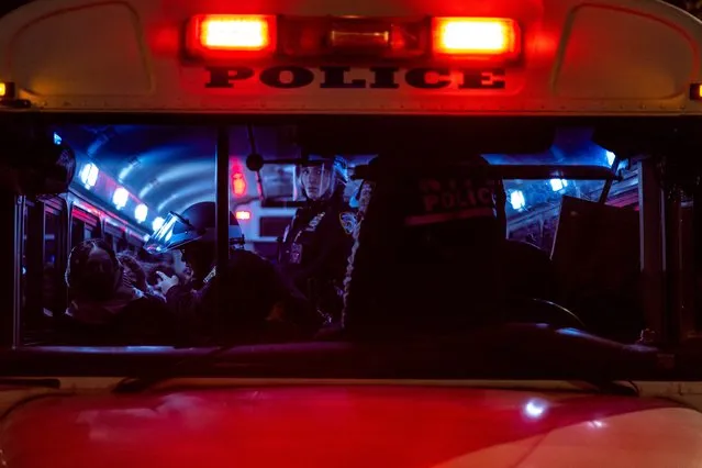 NYPD officers are seen on a bus after detaining pro-Palestinian students and protesters who had set up an encampment on the campus of New York University (NYU) to protest the Israel-Hamas war, in New York on April 22, 2024. Universities have become the focus of intense cultural debate in the United States since the October 7 Hamas attack and Israel's overwhelming military response to it. (Photo by Alex Kent/AFP Photo)