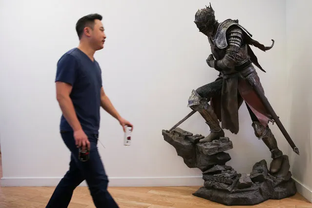 An employee walks past a statue from the video game Dark Souls III at the offices of Twitch Interactive Inc, a social video platform and gaming community owned by Amazon, in San Francisco, California, U.S., March 6, 2017. (Photo by Elijah Nouvelage/Reuters)