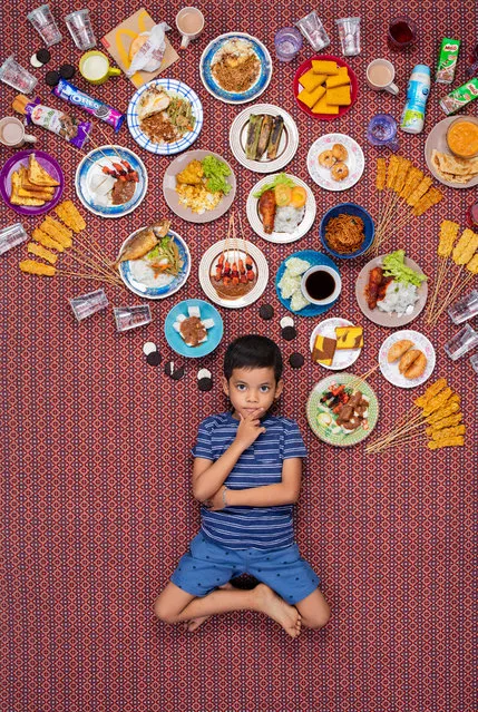 Altaf Rabbal DLove Bin Roni, 6, Gombak, Malaysia, 2017: Altaf and his family live in Kampung Kerdas, a small village of about 30 families on the outskirts of Kuala Lumpur. Altaf’s father makes and sells satay sticks at his own stand. Altaf’s favourite food is his father’s chicken and beef satay. Seasoned with ginger and herbs, it’s roasted over a charcoal fire and served with sliced, cold cucumber. (Photo by Gregg Segal/The Guardian)