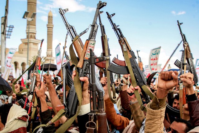 Demonstrators lift up assault rifles as they gather during a pro-Palestinian and anti-Israel rally outside al-Saleh mosque in the Huthi-held capital Sanaa on March 29, 2024 amid the ongoing conflict in the Gaza Strip between Israel and the Palestinian militant group Hamas. (Photo by Mohammed Huwais/AFP Photo)