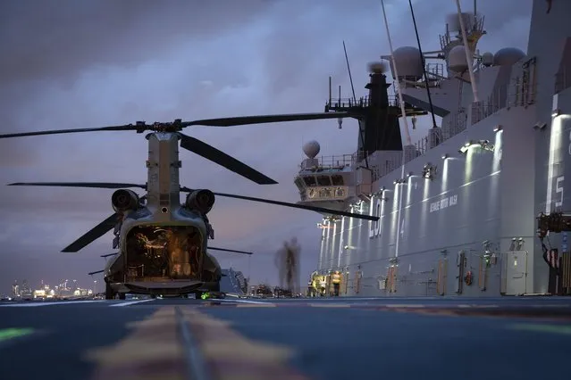 In this photo provided by the Australia Defense Force HMAS Adelaide embarks Chinook Heavy-Lift Helicopters, Wednesday, January 19, 2022, before departing the port of Brisbane, Australia, to provide humanitarian assistance to the Government of Tonga. U.N. humanitarian officials report that about 84,000 people – more than 80% of Tonga's population – have been impacted by the volcano's eruption. (Photo by LSIS David Cox/Australian Defence Force via AP Photo)
