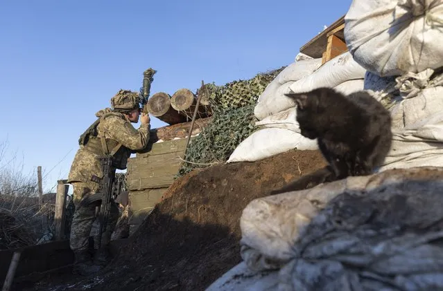 A Ukrainian soldier in a trench at the line of separation from pro-Russian rebels, Donetsk region, Ukraine, Saturday, January 8, 2022. President Joe Biden has warned Russia's Vladimir Putin that the U.S. could impose new sanctions against Russia if it takes further military action against Ukraine. (Photo by Andriy Dubchak/AP Photo)