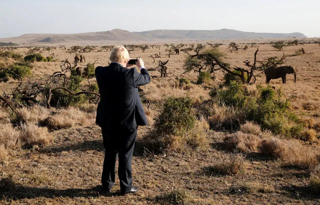 Britain's Foreign Secretary Boris Johnson uses his phone to take a picture of elephants at the Lewa wildlife conservancy sprawling over the Laikipia plains in northern Kenya, March 17, 2017. (Photo by Thomas Mukoya/Reuters)