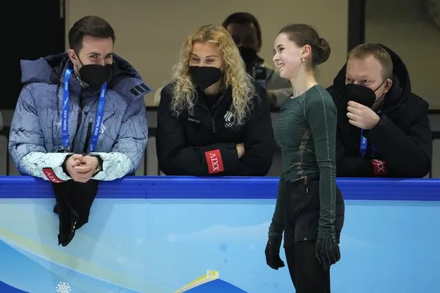 Kamila Valieva, of the Russian Olympic Committee, talks to coaches at a training session at the 2022 Winter Olympics, Thursday, February 10, 2022, in Beijing. (Photo by Jeff Roberson/AP Photo)