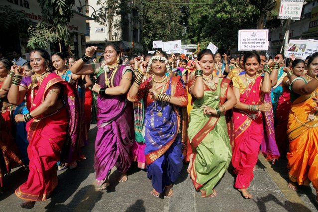 Women from Marathi community performing a group dance as they participate in a community parade (“Shobha Yatra”), to celebrate the Hindu new year “Gudi Padwa”, in Thane, India on Tuesday, March 28, 2017. (Photo by Press Trust of India)