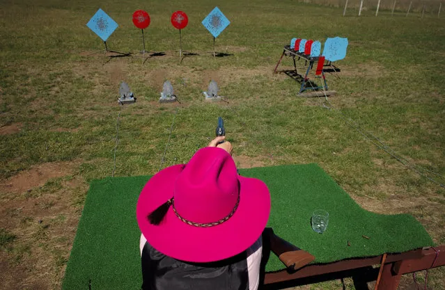 “Pinky Diamond” fires her revolver at a target during the Women of the West shooting competition at the Namoi Pistol Club in Gunnedah in rural New South Wales, Australia April 8, 2017. The annual event featuring women gun enthusiasts is in its fourth year and celebrates the gun-slinging traditions of the American wild-west using replica weapons, run by Australian Cathy Lysaght under her character name “Kitty Pearl”. (Photo by Jason Reed/Reuters)