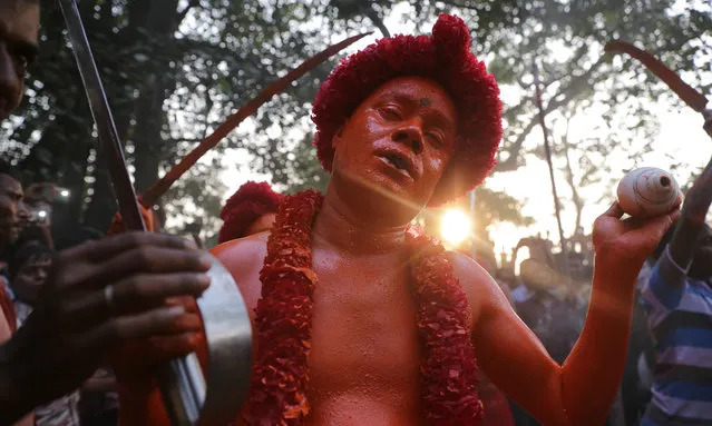 Hindu devotees dance as they take part in a festival called Lal Kach (Red Glass) during the last day of the Bangla month in Munshigonj, Dhaka, Bangladesh on April 13, 2017. (Photo by Mushfiqul Alam/ZUMA Wire/Rex Features/Shutterstock)